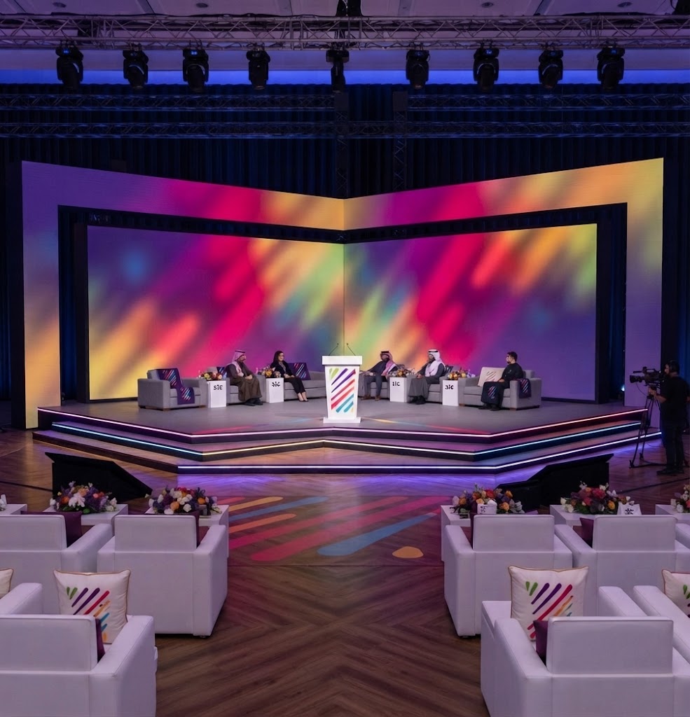 Colorful pink and blue LED stage design with podium for a corporate event