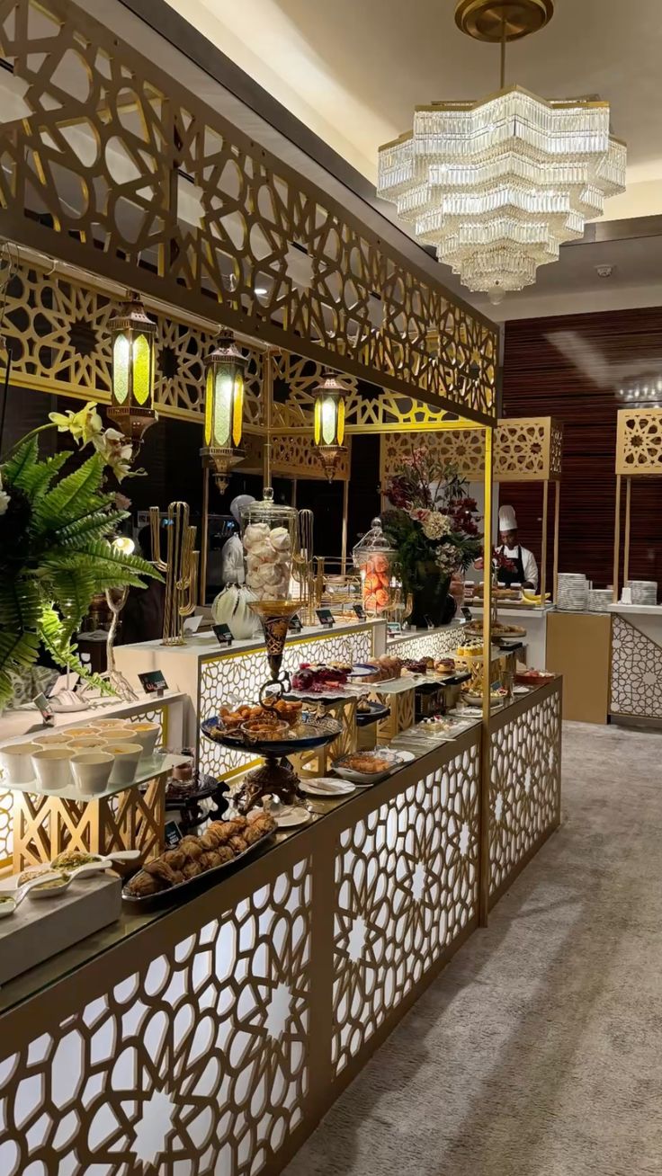 Luxury buffet display with ornate gold decor and chandelier lighting