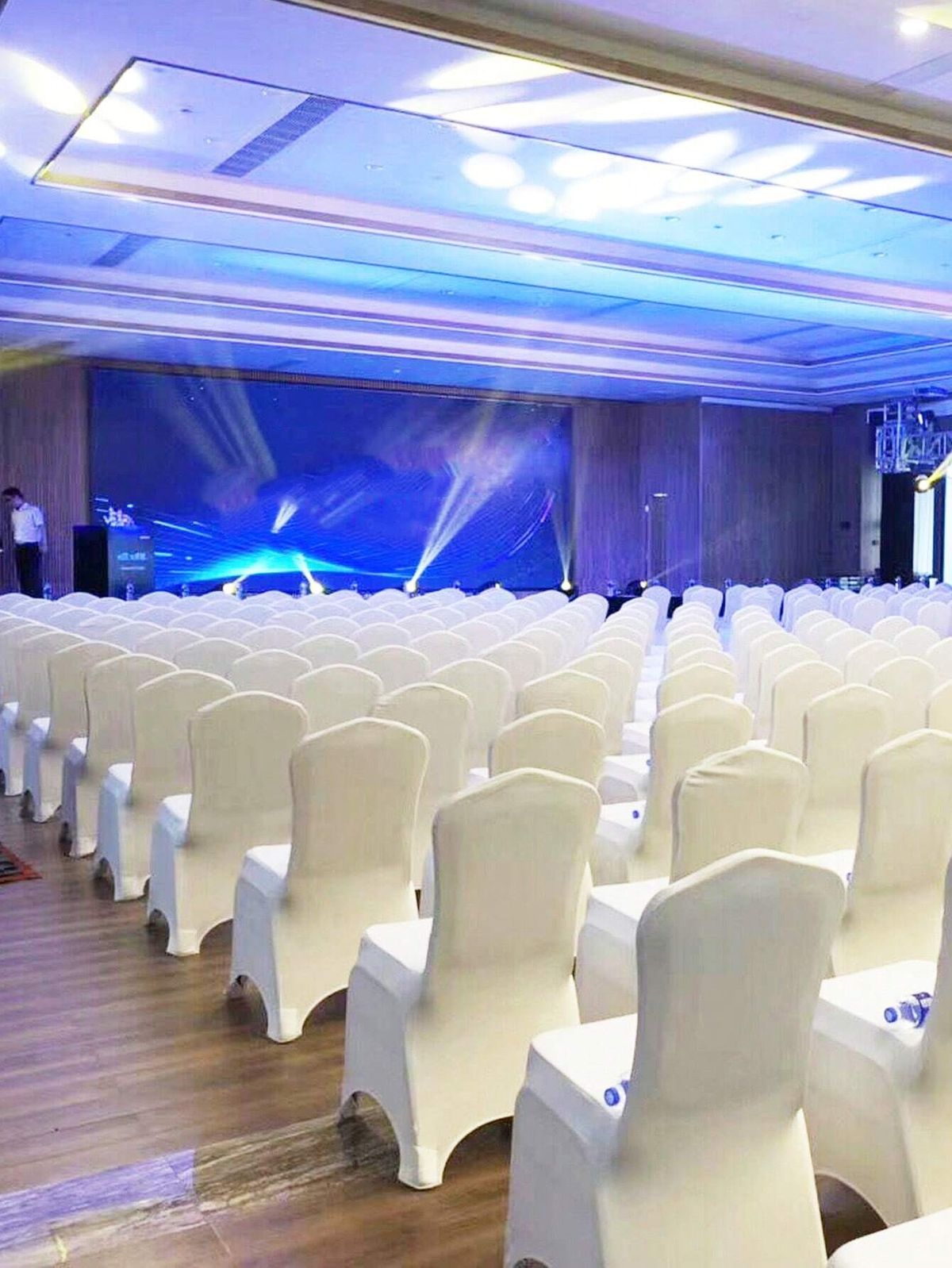 Rows of formal ceremony seating facing a lit stage